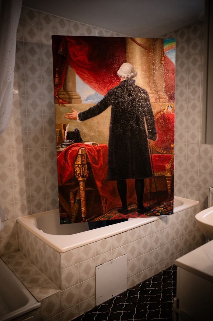 Artist reimagined a famous masterpiece from behind, portraying a man in a black coat within a room.