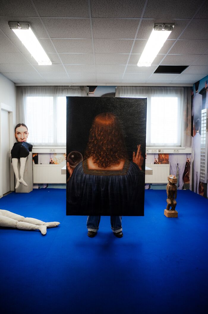 Artist reimagined a famous masterpiece from behind, showing a figure with curly red hair and blue dress.