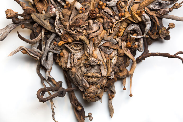 Stunning wood sculpture of a face, made from collected pieces of wood, showcasing the artist's craft.