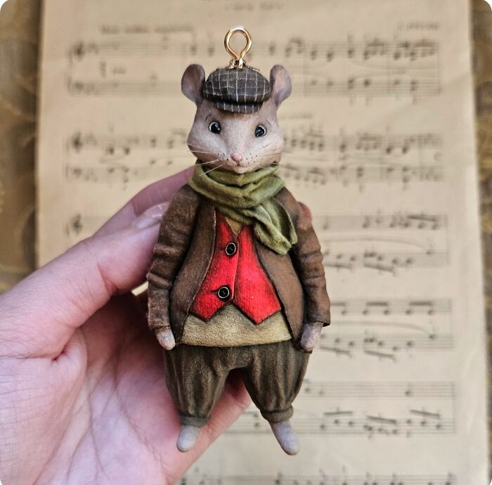 Charming handmade cotton wool mouse wearing a hat and scarf, an artistic creation.