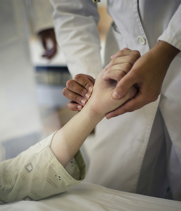 A medical professional comforting a young Canadian boy, highlighting the tragic loss of life after a bat encounter. A medical professional comforting a young Canadian boy, highlighting the tragic loss of life after a bat encounter.