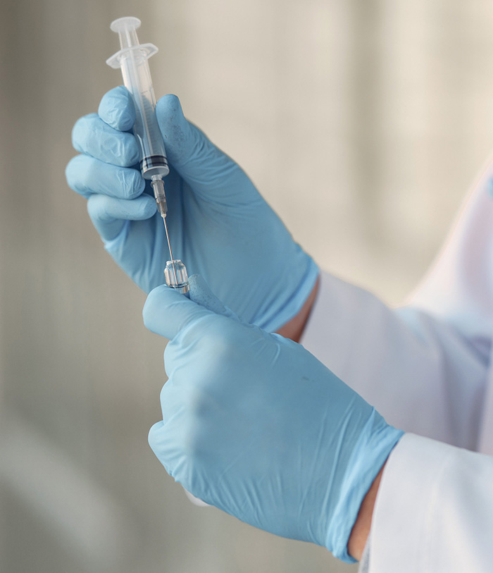 A medical professional preparing a syringe, symbolizing the need for rabies treatment after a Canadian boy's tragic loss of life from a bat. A medical professional preparing a syringe, symbolizing the need for rabies treatment after a Canadian boy's tragic loss of life from a bat.