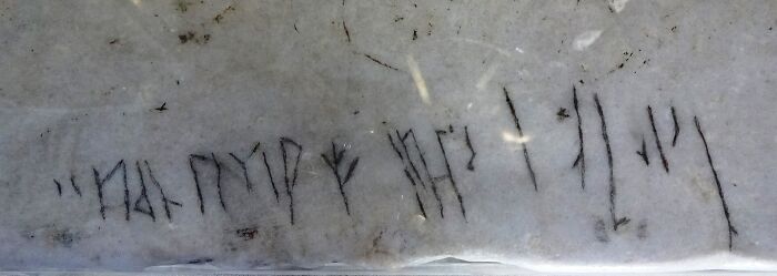 Ancient runic carvings on a stone surface, an intriguing piece of history facts.