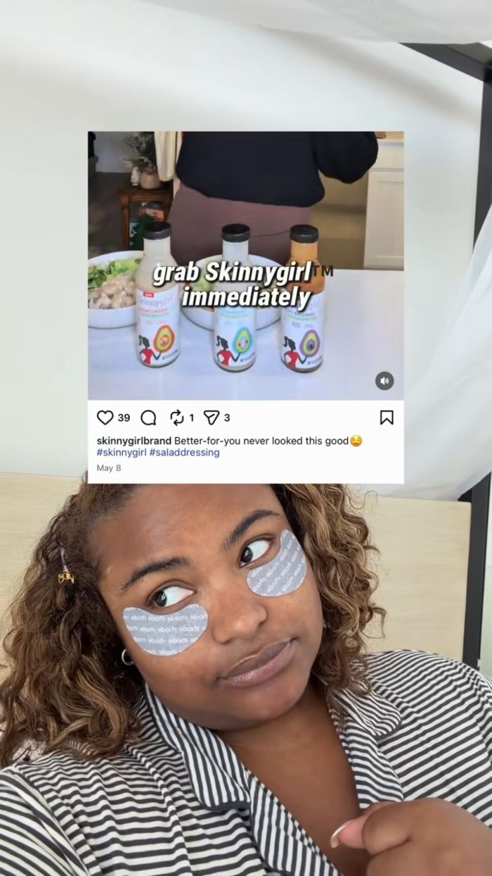 A plus size activist with under-eye patches, showing an Instagram post by Skinnygirl brand, calling out fatphobic marketing. A plus size activist with under-eye patches, showing an Instagram post by Skinnygirl brand, calling out fatphobic marketing.