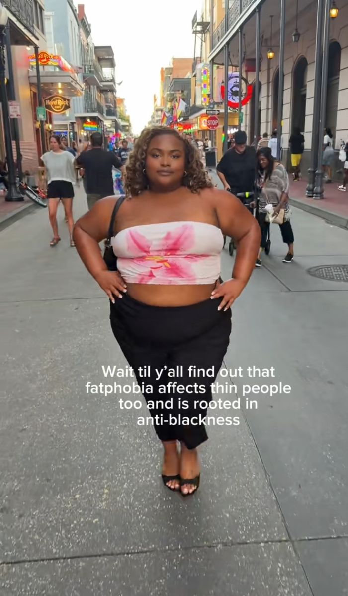Plus size activist on a street, discussing how fatphobia affects people and its roots in anti-blackness. Plus size activist on a street, discussing how fatphobia affects people and its roots in anti-blackness.
