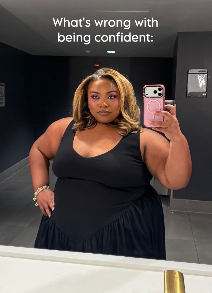 Confident plus size activist taking a mirror selfie, addressing the topic of fatphobic brands. Confident plus size activist taking a mirror selfie, addressing the topic of fatphobic brands.