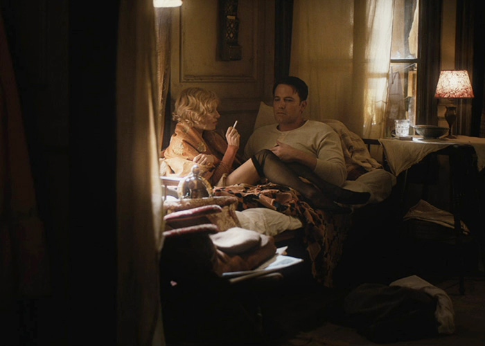 A woman smoking in bed next to a man, showing intimate scenes that look different behind-the-scenes.