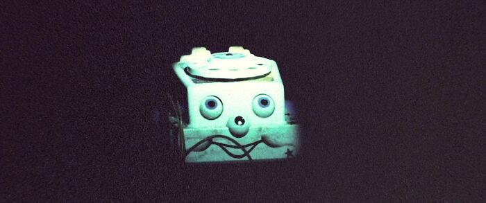 A creepy toy telephone with glowing eyes, from one of the most terrifying horror movies.