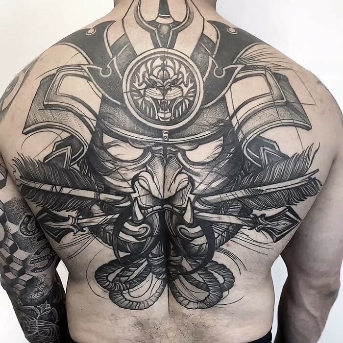 Detailed black and white samurai warrior tattoo art covering a mans entire back, showcasing inspiring tattoo art.