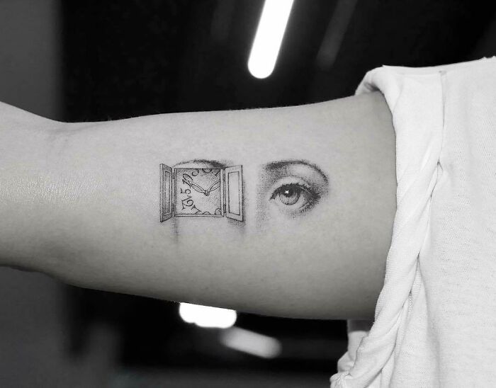 Minimalist eye and window with clock tattoo art on an arm, inspiring examples.