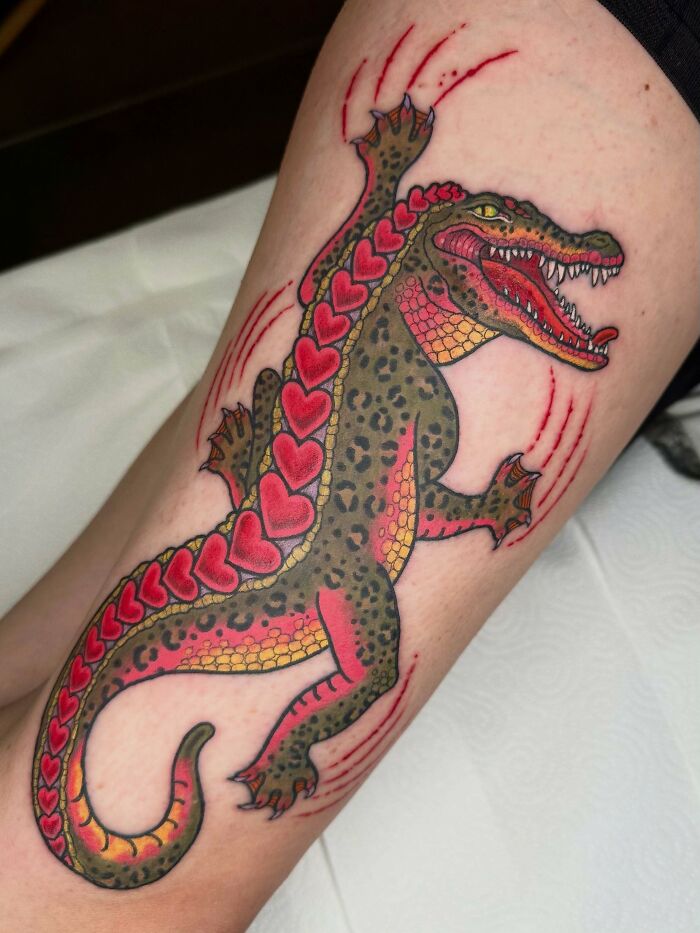 Colorful alligator tattoo art with heart-shaped scales, inspiring examples.