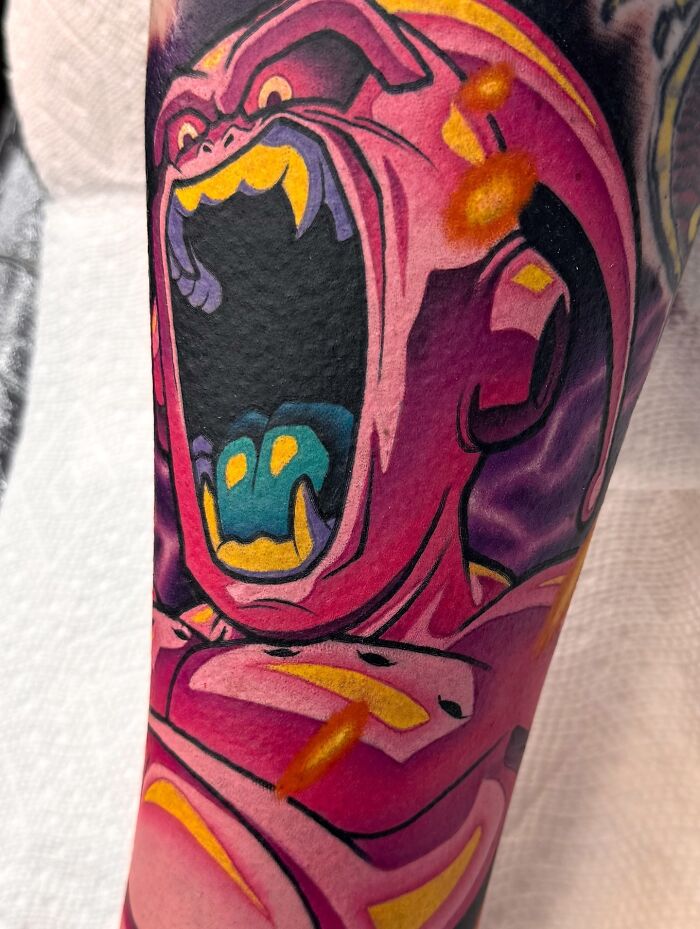 Close-up of a colorful, screaming monster tattoo art on an arm, an inspiring example of tattoo art.