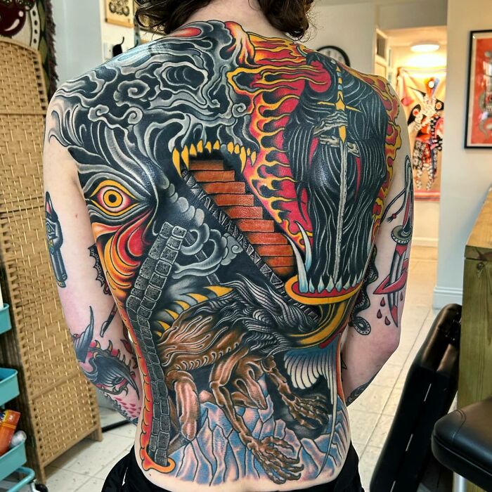 Full back tattoo art featuring a vibrant, intricate mythical creature design, showcasing inspiring tattoo art.