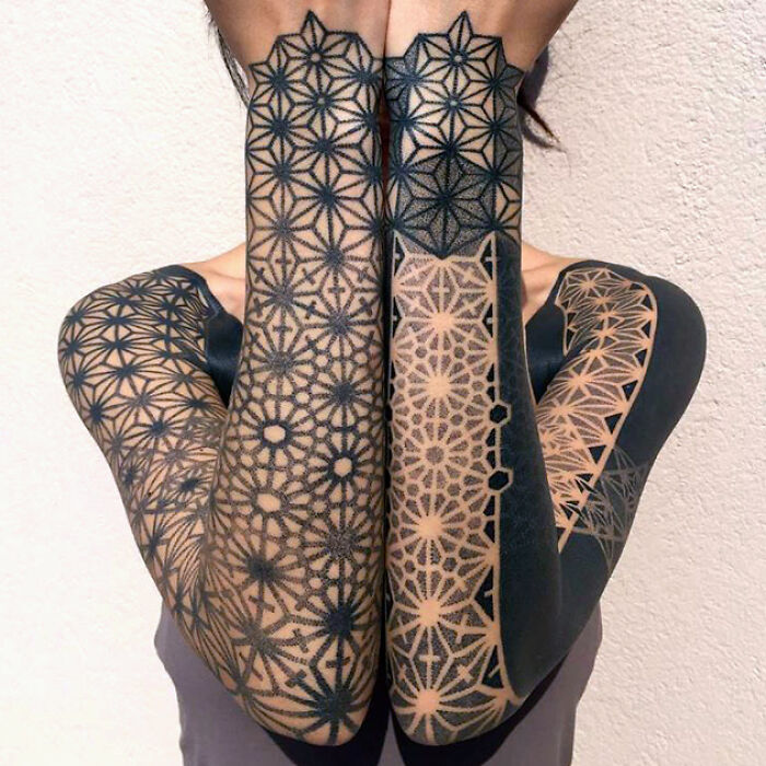 Full arm geometric pattern tattoo art in black ink, demonstrating inspiring and precise tattoo art.