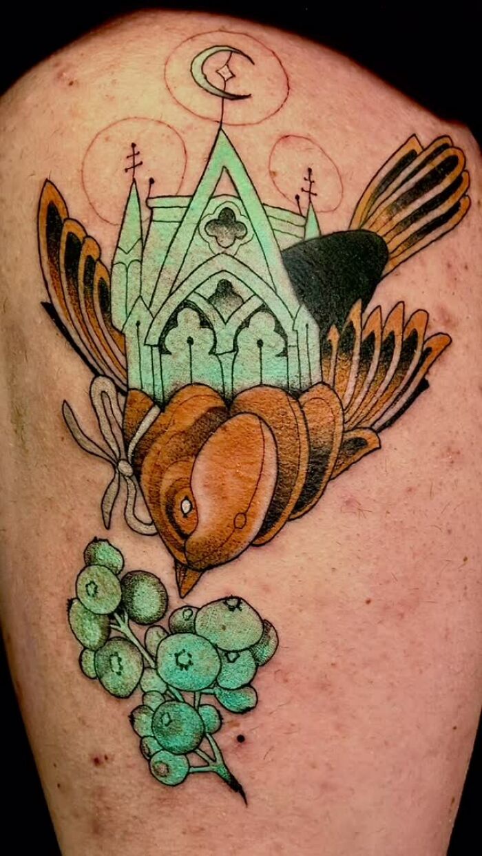 Whimsical bird tattoo art with a church-like structure and berries, an inspiring piece of tattoo art.
