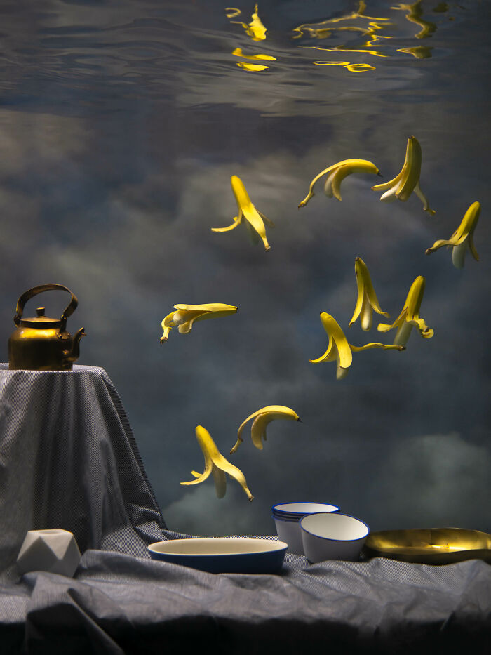 Surreal photos of banana peels floating in water, with a teapot and bowls creating a serene underwater composition.