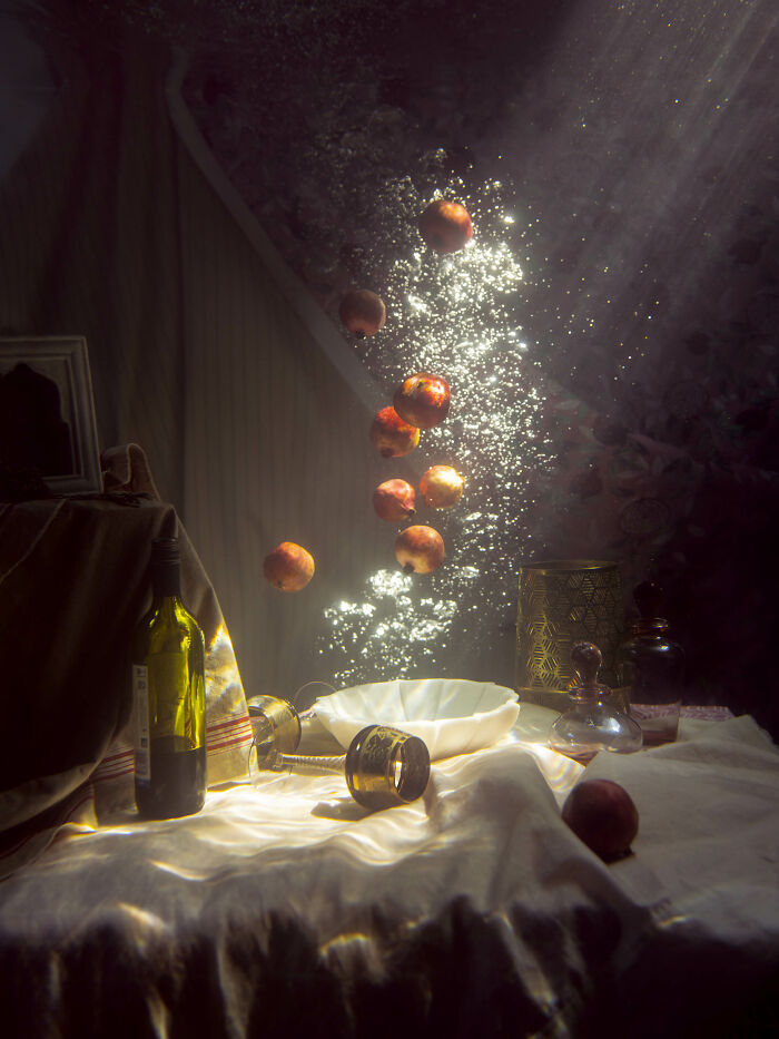Surreal photos of peaches bubbling in water, with light streaming through the surface, creating an aquatic still life.