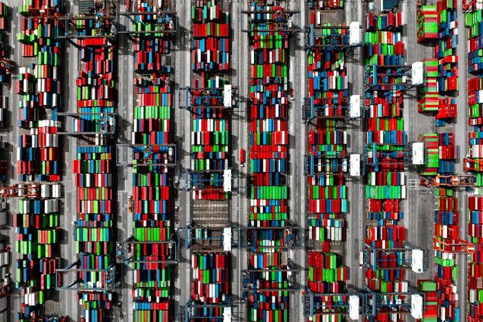 Remarkable color photo capturing the world: an aerial view of a port filled with hundreds of colorful shipping containers.
