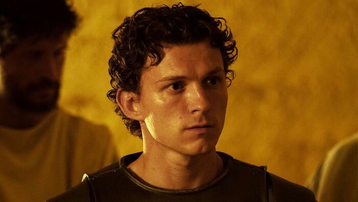 Christopher Nolan's Odyssey: Tom Holland in costume, looking serious in a new photo.
