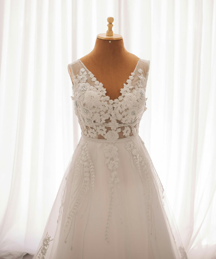 An elegant white wedding dress on a mannequin, symbolizing issues with MILs.