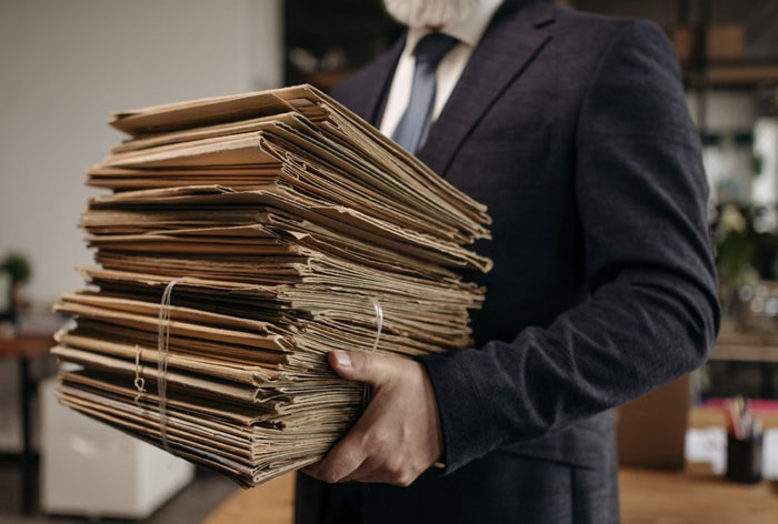 Image of a man carrying a large stack of files, symbolizing the recovery after the IT guy quit. Image of a man carrying a large stack of files, symbolizing the recovery after the IT guy quit.