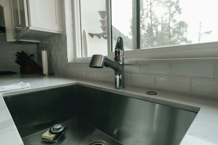 A kitchen sink with a sponge, signaling to guests they may never return to this home.