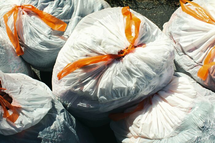 Bags of trash tied with orange string, representing an instant decision by guests not to return to this home.