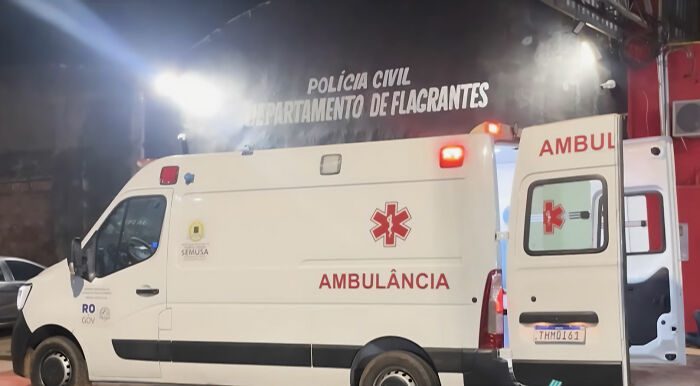 An ambulance parked outside a building with the words POLICIA CIVIL, related to a fatal revenge plot investigation.