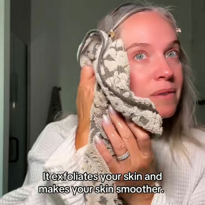 Woman wiping her face with a towel after shaving, explaining how it exfoliates skin and makes it smoother.