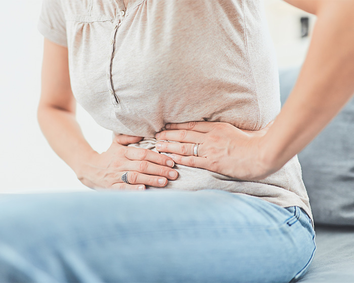 A person clutching their stomach, symbolizing the medical emergency that led to Icon Bonnie Tyler's passing. A person clutching their stomach, symbolizing the medical emergency that led to Icon Bonnie Tyler's passing.