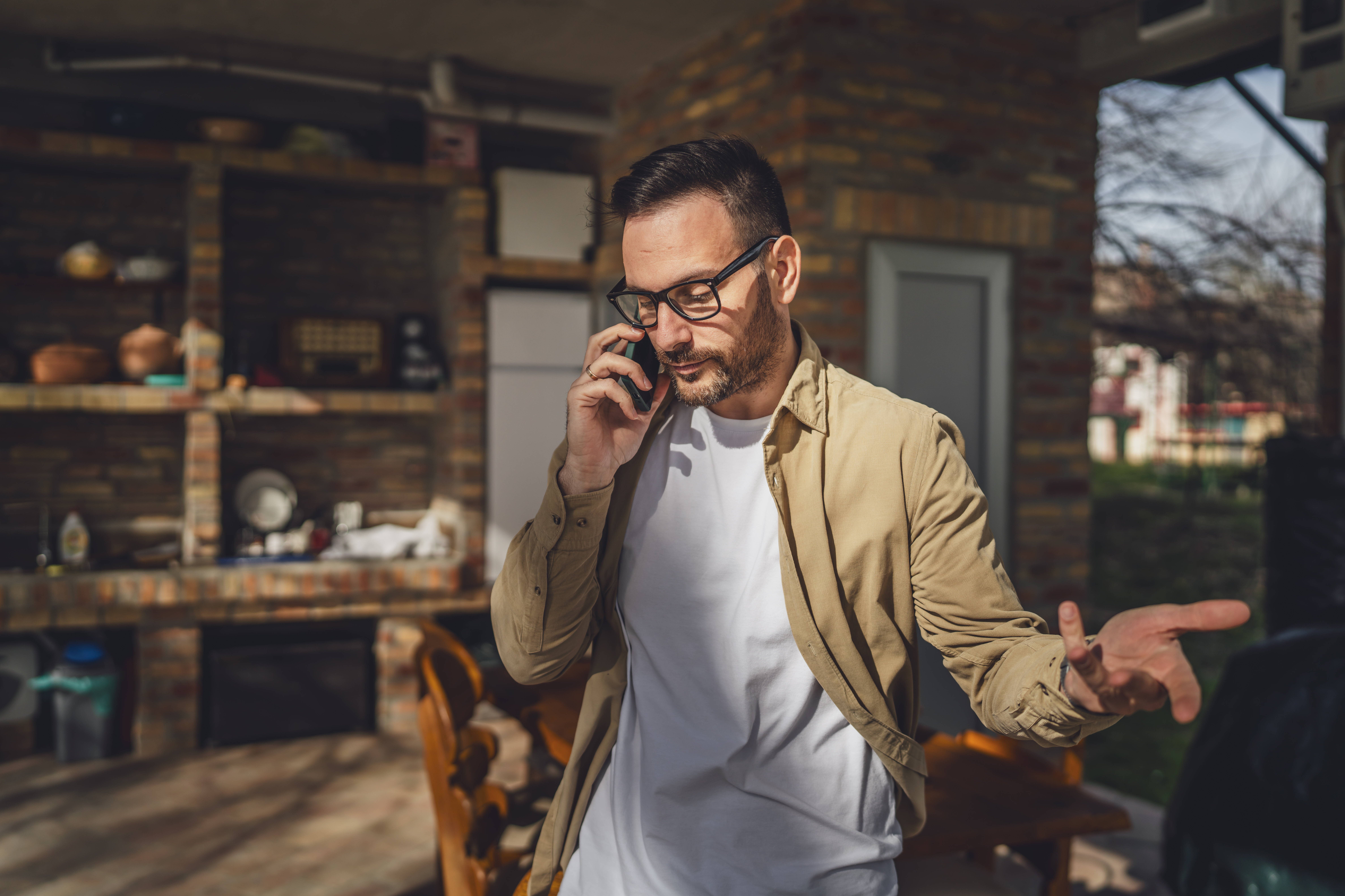 A man on the phone, visibly upset, as the son finally spills the tea on his gossiping mom.