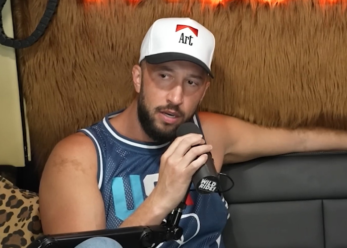 A man speaking into a microphone, discussing the adult star and her permanent disability and $3M payout. A man speaking into a microphone, discussing the adult star and her permanent disability and $3M payout.