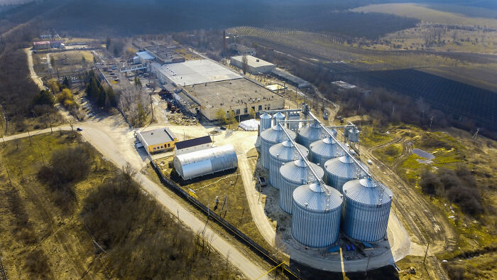 Aerial view of a large industrial complex with silos, an example of unpopular industries that make millions.