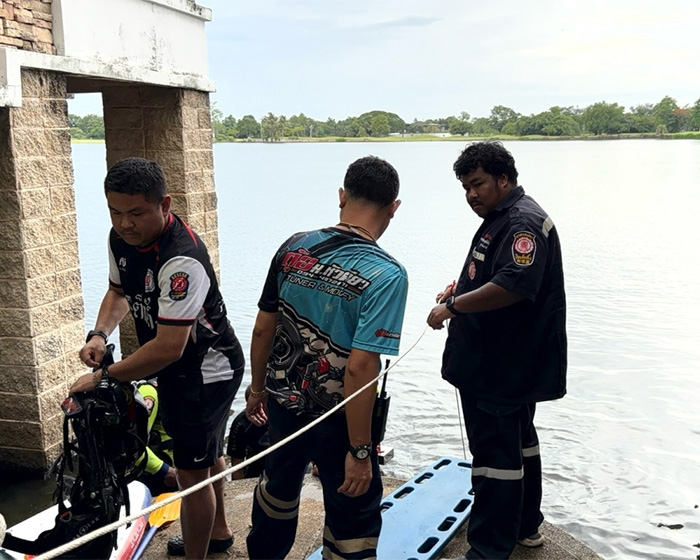 Emergency responders near a lake, preparing diving gear for a search related to the lookmaxxer's passing. Emergency responders near a lake, preparing diving gear for a search related to the lookmaxxer's passing.