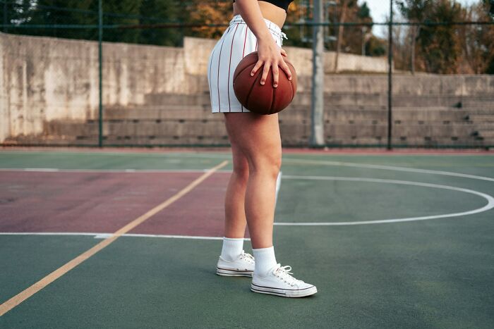 A person holding a basketball, unrelated to medical mistakes, but possibly a break from medical topics.