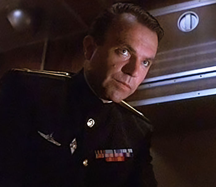 Sam Neill as a Russian officer in a dark uniform, looking intently. Fans react to Alec Baldwin's tribute. Sam Neill as a Russian officer in a dark uniform, looking intently. Fans react to Alec Baldwin's tribute.
