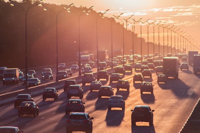 A busy highway at sunset, filled with cars, illustrating disturbing things witnessed in public.