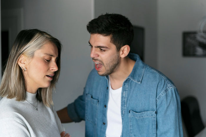 A man yelling at a woman, depicting a violent reaction after she accidentally serves allergic SIL peanuts. A man yelling at a woman, depicting a violent reaction after she accidentally serves allergic SIL peanuts.