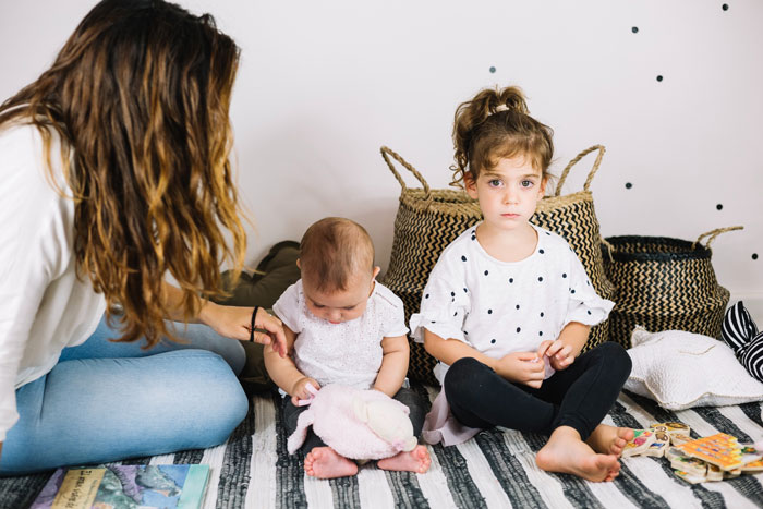 Mother with two children, a toddler and an infant, who are allergic to peanuts. Mother with two children, a toddler and an infant, who are allergic to peanuts.