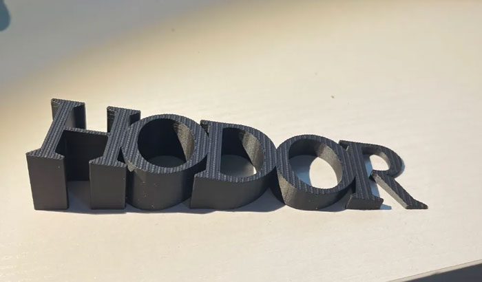 A 3D printing creation spelling HODOR, demonstrating amazing 3D printing.
