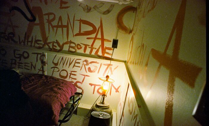 A wall covered in graffiti and a lamp, possibly part of a crazy office story from someone's final day at work.