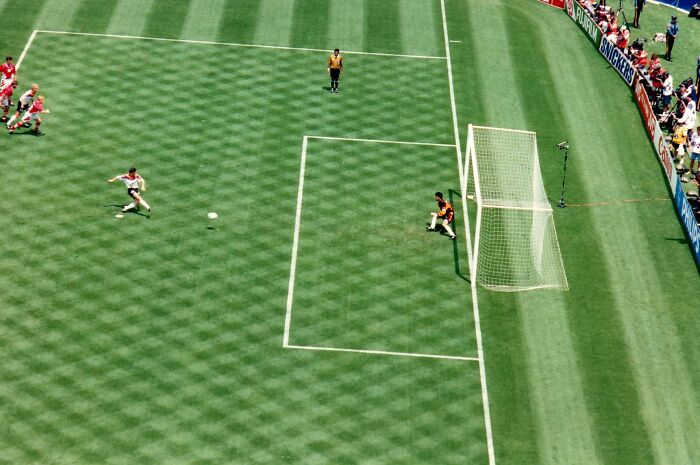 An aerial view of a soccer game, where a woman predicted the 9/11 event from a distance.