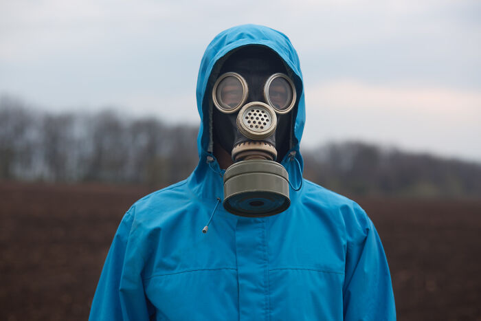 A person wearing a gas mask, symbolizing the unsettling call of the woman who predicted 9/11.