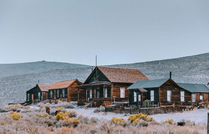 Rustic wooden houses at a wedding venue, where the groom's friend misses the wedding due to withdrawal issues. Rustic wooden houses at a wedding venue, where the groom's friend misses the wedding due to withdrawal issues.