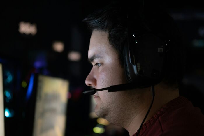 A man wearing a headset with a microphone, concentrating, illustrating mansplaining examples.