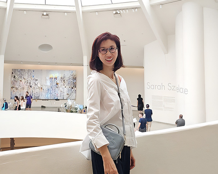 A woman smiling in an art gallery, likely the wife involved in the newsworthy billionaire divorce. A woman smiling in an art gallery, likely the wife involved in the newsworthy billionaire divorce.