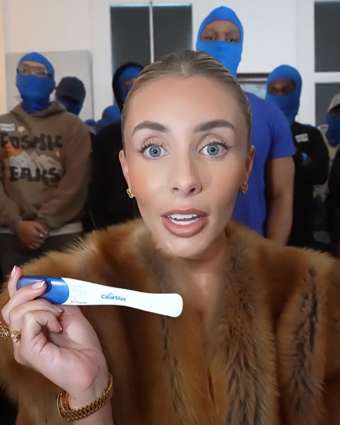 Bonnie Blue holds a pregnancy test, announcing her baby bump during the July 4 event.