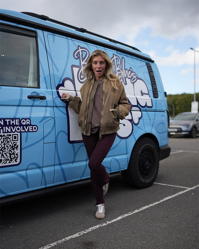 Bonnie Blue posing in front of a blue van, revealing her life before fame.