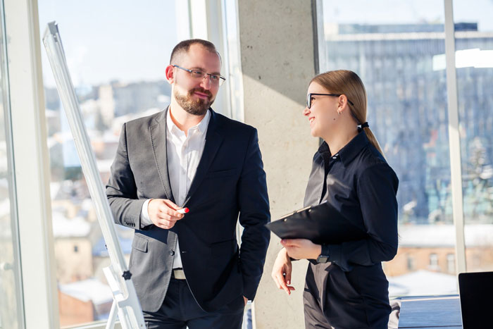 A worker and a boss discussing business strategy, unknowingly involved in hidden fraud. A worker and a boss discussing business strategy, unknowingly involved in hidden fraud.