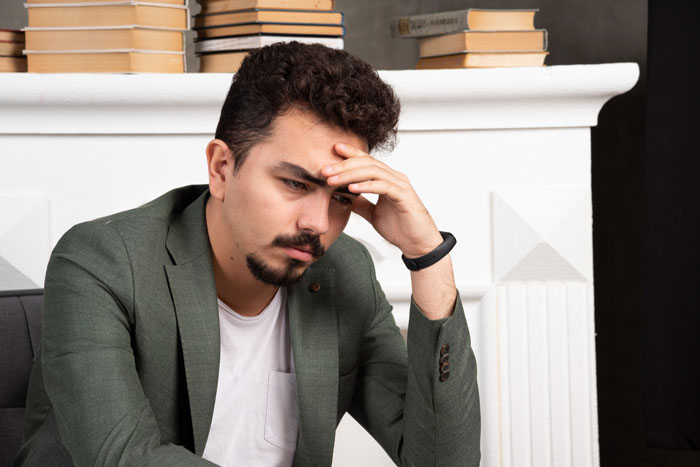 A thoughtful worker, representing the person who kept proof of bosses' fraud hidden for years. A thoughtful worker, representing the person who kept proof of bosses' fraud hidden for years.